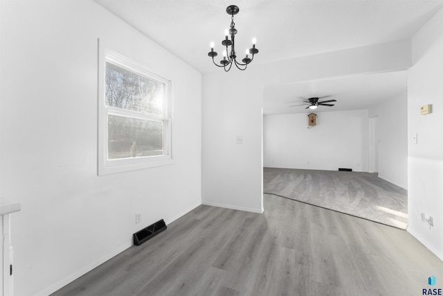 interior space with light hardwood / wood-style flooring and ceiling fan with notable chandelier