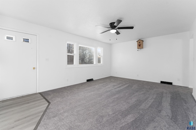 empty room featuring carpet flooring and ceiling fan