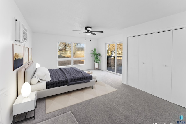 carpeted bedroom featuring access to exterior, a wall mounted AC, a closet, and ceiling fan