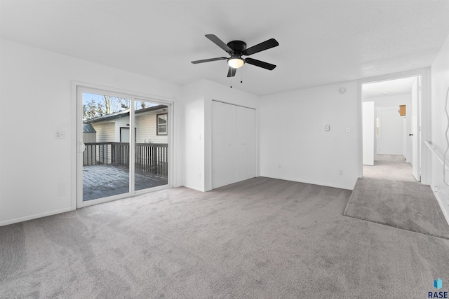 unfurnished living room with carpet and ceiling fan