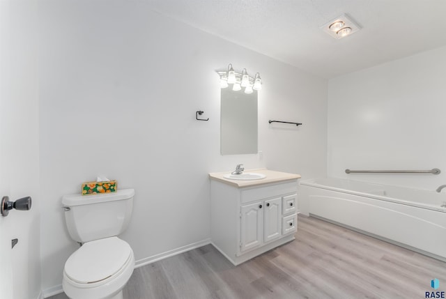 bathroom with vanity, hardwood / wood-style flooring, and toilet