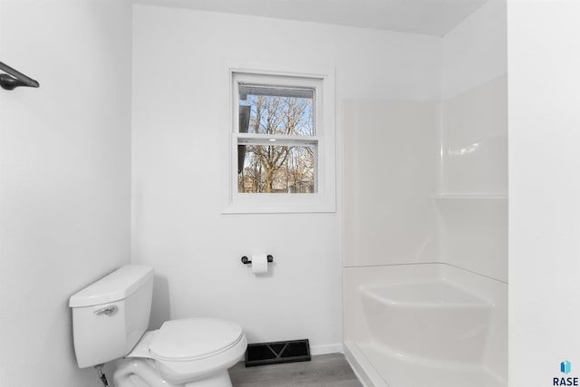 bathroom with hardwood / wood-style floors and toilet