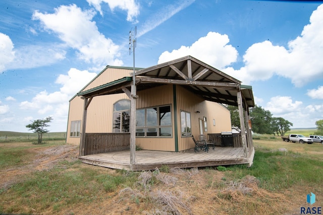 rear view of property featuring a wooden deck