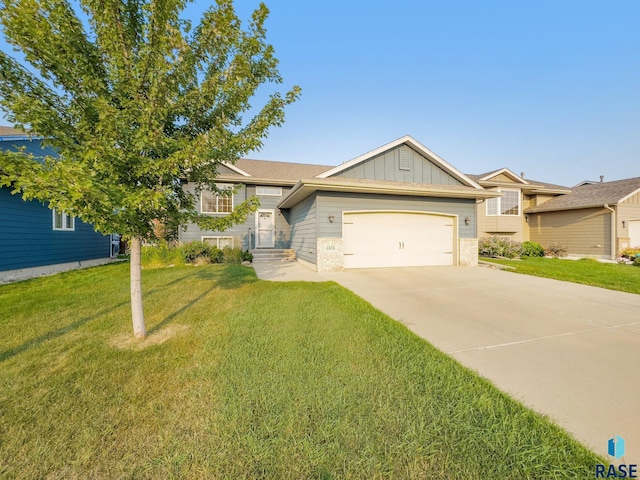 view of front of house with a garage and a front lawn