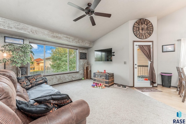 living room with ceiling fan, lofted ceiling, and light hardwood / wood-style flooring