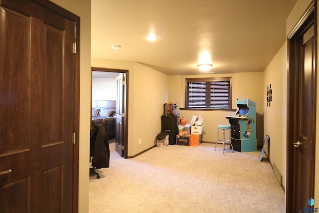 interior space featuring light carpet and baseboards