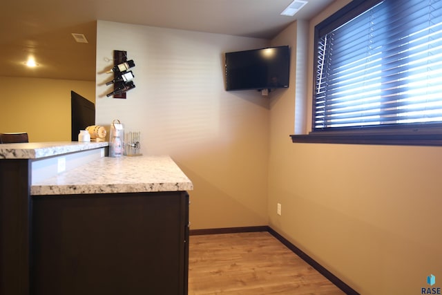 bar featuring light hardwood / wood-style floors