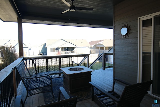 view of wooden balcony featuring a fire pit, ceiling fan, and a wooden deck