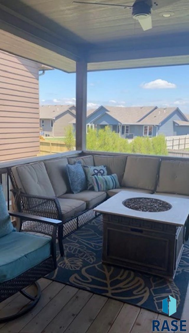 view of patio / terrace with a residential view and an outdoor living space with a fire pit