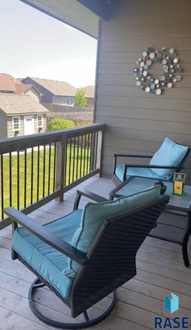 wooden deck with a residential view and a yard