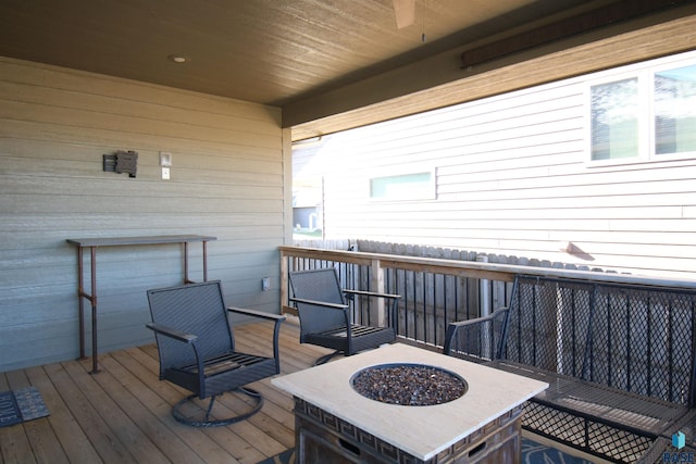 wooden terrace featuring a fire pit