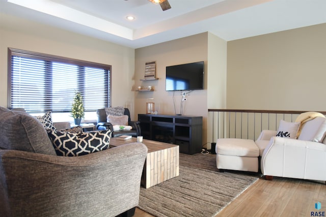 living room with hardwood / wood-style flooring and ceiling fan