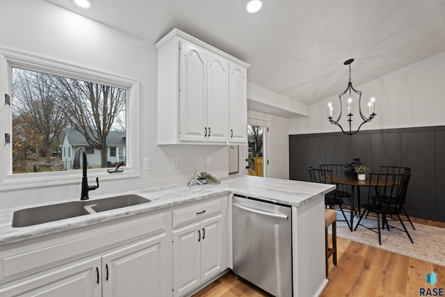 kitchen featuring dishwasher, sink, kitchen peninsula, white cabinets, and light wood-type flooring