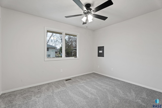 carpeted spare room with ceiling fan