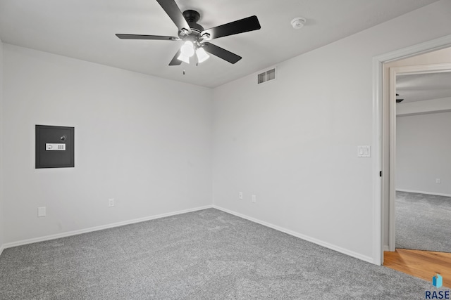 carpeted spare room with ceiling fan