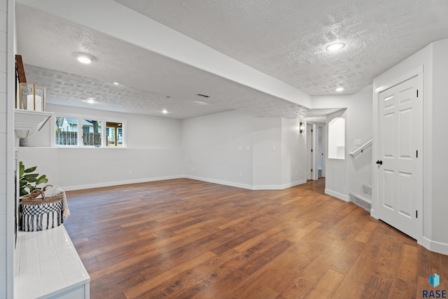 basement featuring hardwood / wood-style floors and a textured ceiling