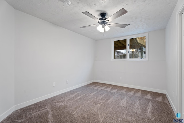 empty room with carpet, ceiling fan, and a textured ceiling