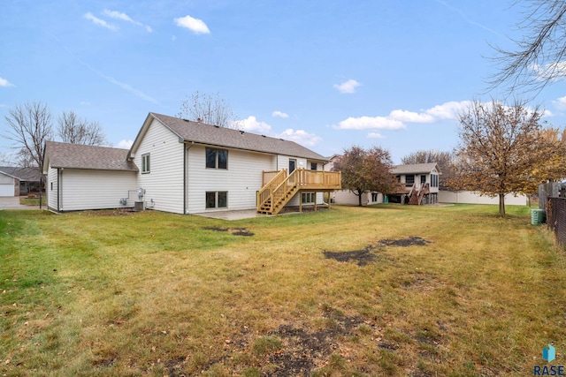 back of property featuring a lawn and a wooden deck