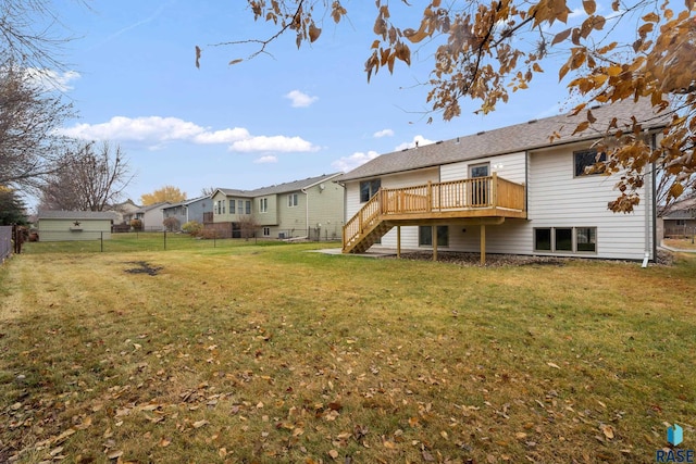 back of house featuring a yard and a deck