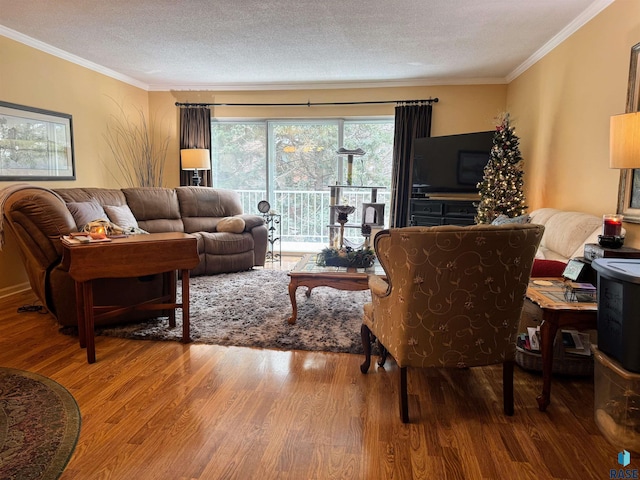 living room featuring wood-type flooring, a textured ceiling, and ornamental molding