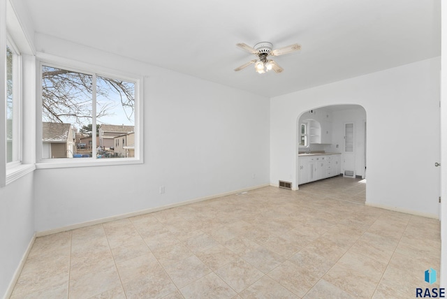 empty room with ceiling fan and sink