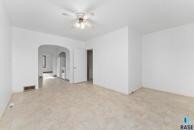 spare room with ceiling fan and light tile patterned floors