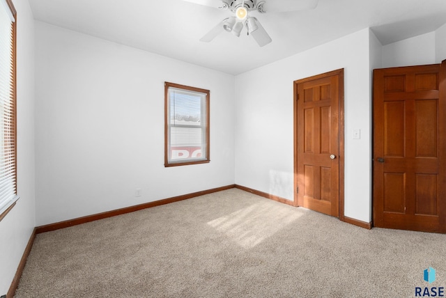 unfurnished bedroom featuring ceiling fan and light colored carpet