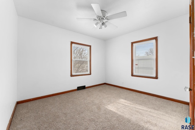 spare room with carpet and ceiling fan