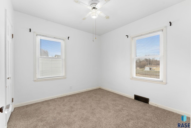 spare room featuring ceiling fan and light colored carpet