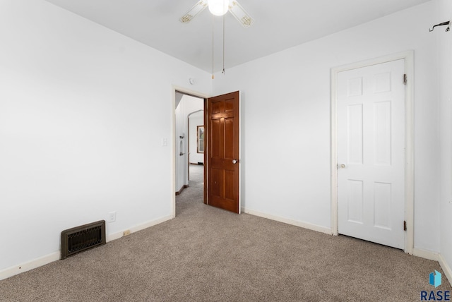 unfurnished bedroom with ceiling fan and carpet floors