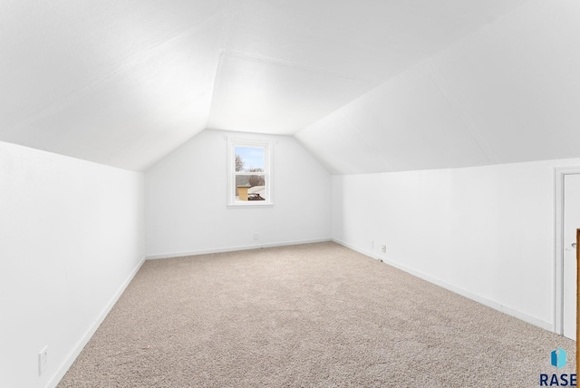 bonus room with carpet and vaulted ceiling