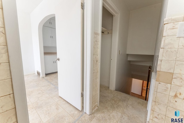 hallway featuring light tile patterned floors