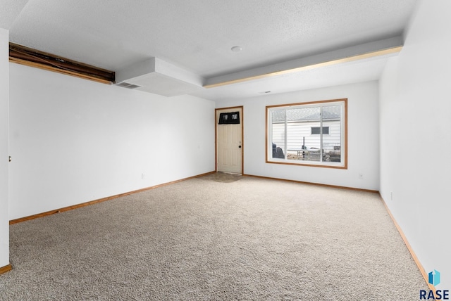 unfurnished room featuring carpet flooring and a textured ceiling