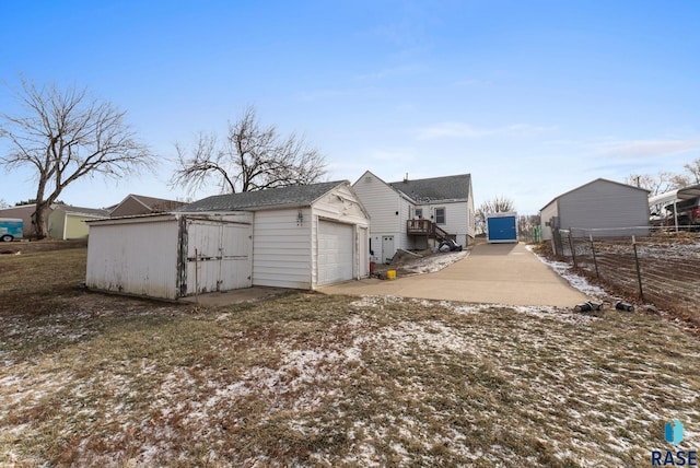 view of side of home with a garage and an outdoor structure