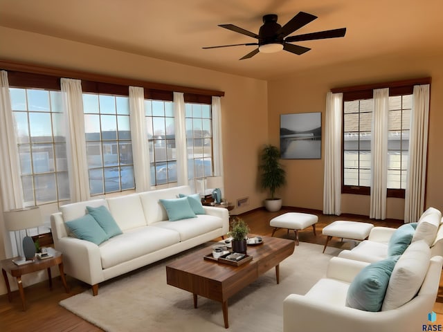 living room with light hardwood / wood-style flooring, plenty of natural light, and ceiling fan