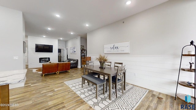 dining area featuring a fireplace and light hardwood / wood-style floors