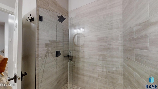 bathroom featuring a shower with door