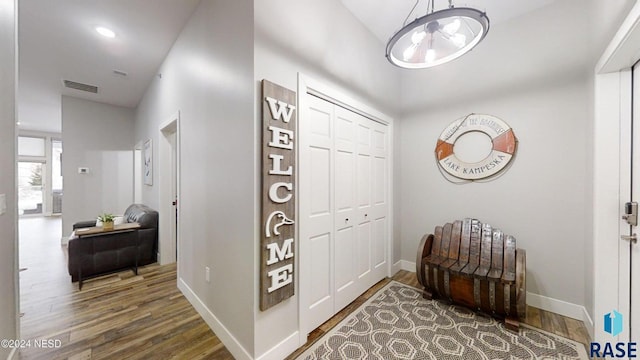 hallway featuring a chandelier and dark hardwood / wood-style floors