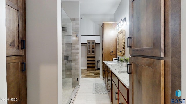 bathroom featuring vanity and a shower with door