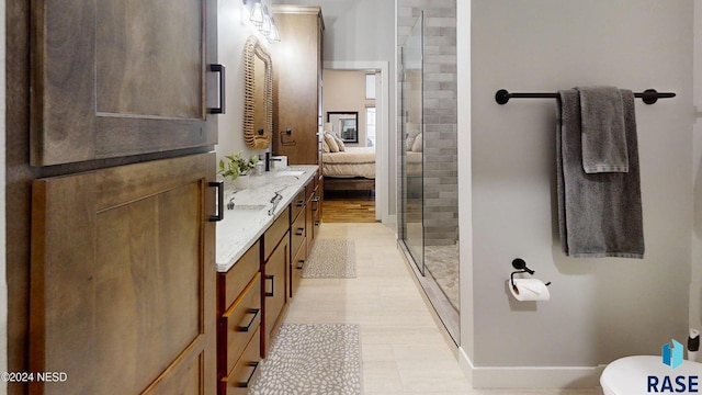 bathroom with tile patterned floors, vanity, a shower with shower door, and toilet