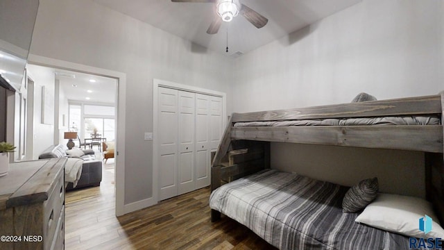 bedroom with dark hardwood / wood-style flooring, a closet, high vaulted ceiling, and ceiling fan