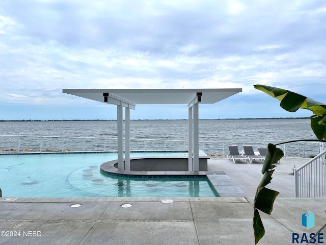 view of swimming pool featuring a water view