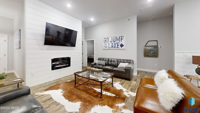 living room with a fireplace and light hardwood / wood-style flooring