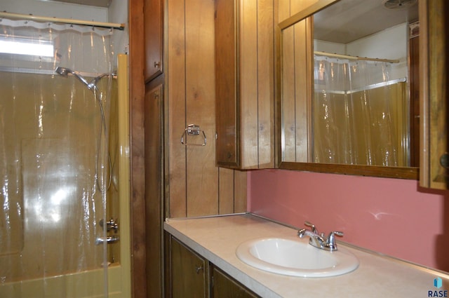 bathroom featuring vanity and shower / bathtub combination with curtain