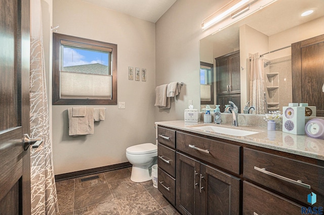 bathroom with a shower with shower curtain, vanity, and toilet