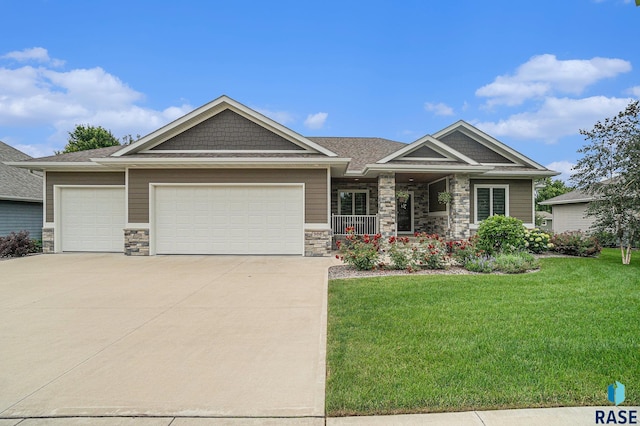 craftsman-style home featuring a front yard and a garage