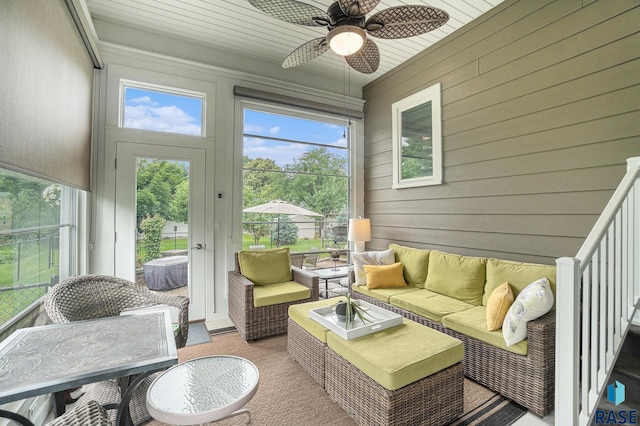 sunroom with ceiling fan and wood ceiling