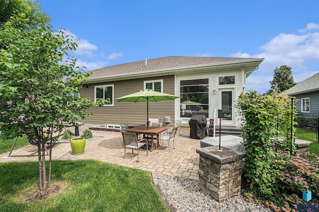 back of property featuring a lawn and a patio area