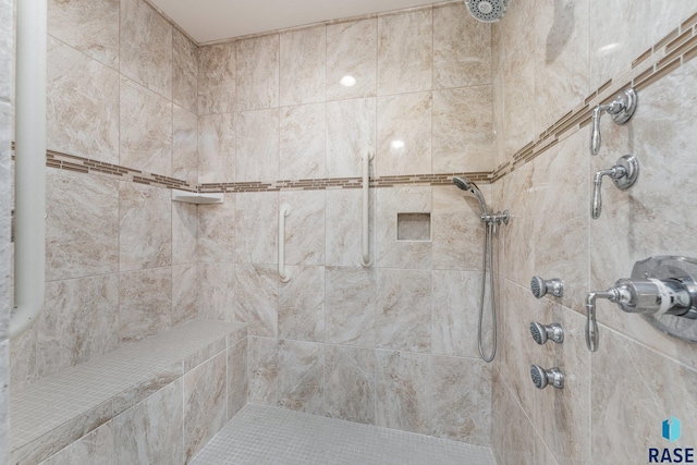 bathroom with a tile shower