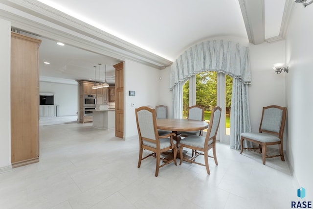 dining space featuring crown molding and light tile patterned floors